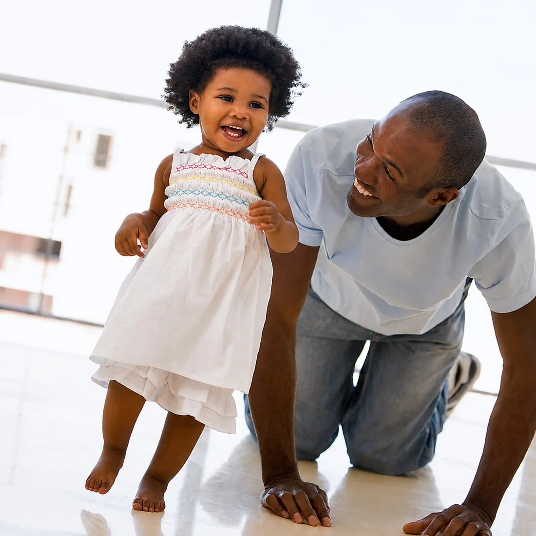 A father playing with his young daughter